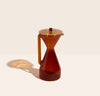 The Amber Pour Over Carafe on a cream background. 