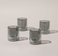 Four 6 oz Gray Double Wall Glasses on a cream background. 