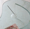 The Clear Glass Meso Incense Holder on a glass surface. 