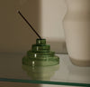 The Verde Glass Meso Incense Holder on a cream background.