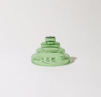 The Verde Glass Meso Incense Holder on a grayish background.