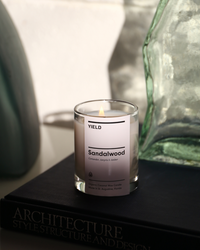 Yield 6oz Sandalwood Candle in a relaxed setting.