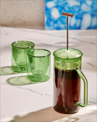 The Yield Verde 6 oz Double Wall Glass and French Press Bundle on a Marble Countertop.