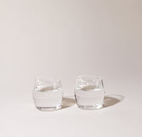 Two 6 oz Clear Century Glasses filled with water on a cream background. 