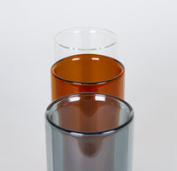 Top view of the Clear, Amber and Gray Double Wall Glasses on a greyish background.