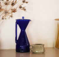 The Cobalt Pour Over Carafe on a cream background. 